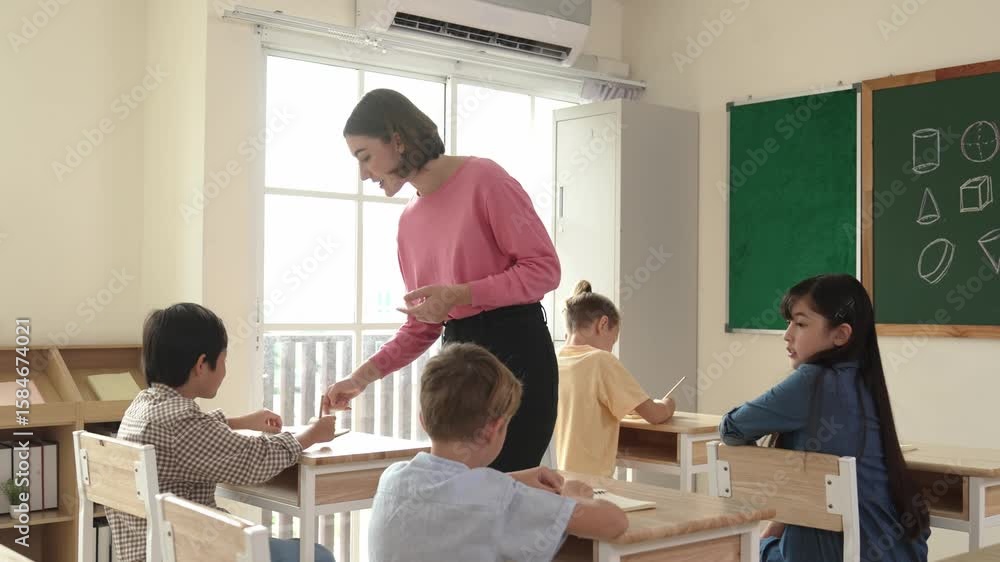 Aufkleber caucasian teacher walking and check student homework at classroom while diverse children doing class