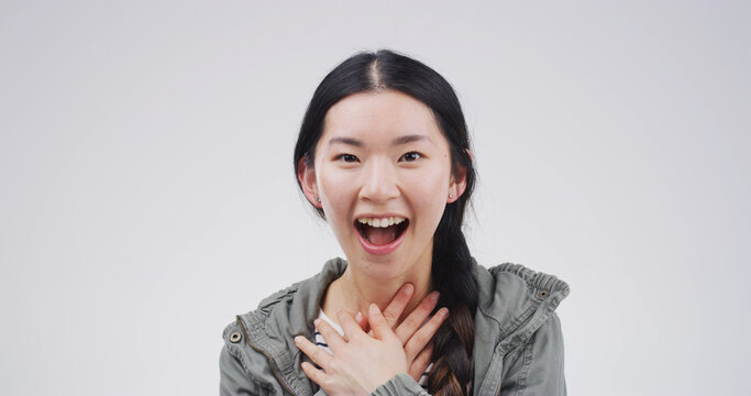 Shock, winner and portrait with asian woman in studio for excited, scholarship or deans list announcement. Surprise, academic merit and student reward with person on white background space for news