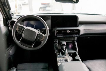 Modern Car Interior Showing Steering Wheel, Dashboard, and Leather Seats