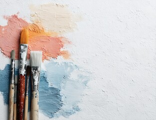 Paintbrushes and color swatches on textured surface