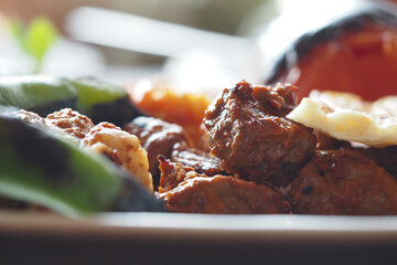 Grilled meat and vegetables on a plate at a summer gathering