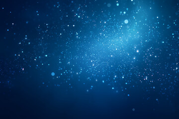 Fototapeta premium Sparkling blue particles drift across dark background