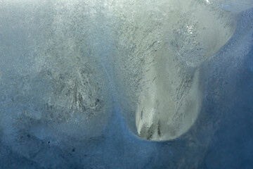 Abstract of ice on a cliff looks like diving seals.