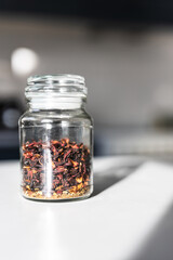 loose leaf tea in glass jar  on kitchen countertop, wellness health benefits and cosy tea time...