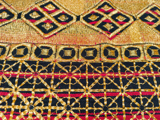 Kain tapis or Lampung tapis fabric with golden threads, geometric motifs, and traditional woven textures.
gold background or ethnic background concept
