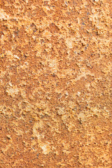 Corroded rusty metal surface with flaky texture close-up.