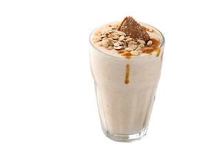 Honey cinnamon almond milkshake in glass with crushed nuts and drizzle on white