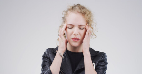 Student, pain and girl with headache in studio for exam stress, workload burnout and overwhelmed....