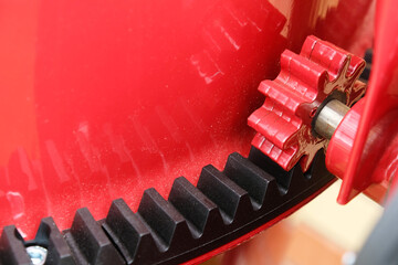 Fragment of a concrete mixer, view of the drive gear and polyamide crown close-up. Construction tool for preparing concrete mix.