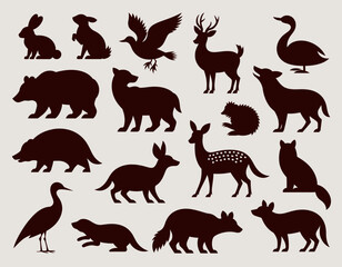 Fototapeta premium A collection of silhouette illustrations featuring various animals, including a rabbit, bear, deer, swan, and other wildlife species.