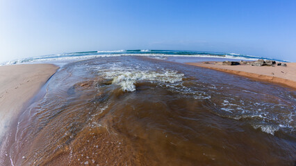 River Mouth Water Flowing Through Beach Towards Blue Ocean
