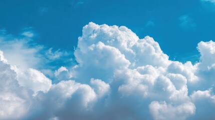 Fluffy white clouds against a bright blue sky, creating a serene and tranquil atmosphere ideal for relaxation.