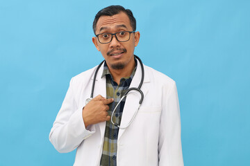 Asian male doctor wearing doctor's coat, stethoscope hanging around neck, surprised and ambushed,...
