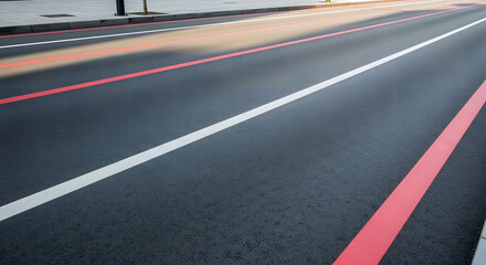 Fresh asphalt road showing white and red traffic lines, ideal for urban development, transportation, or travel themes, demonstrating modern infrastructure.