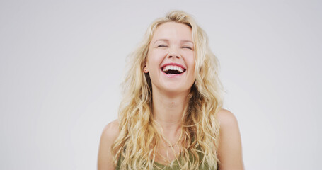Laughing, smile and face of woman in studio with funny joke, humor or comedy on white background....