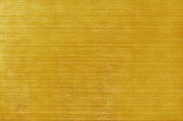 Golden yellow aluminium metal texture background, scratches on polished stainless steel.