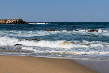 breaking waves and rocks at the sea