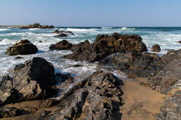 breaking waves and rocks at the sea