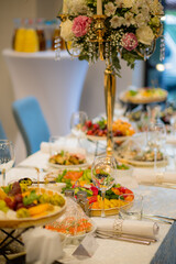 A beautifully arranged banquet table filled with vibrant dishes and stunning floral decorations