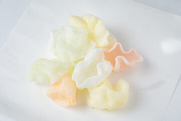 Delicate shrimp chips in pastel hues are creatively arranged, inviting a flavorful snack experience