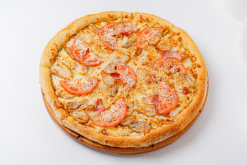 A mouthwatering pizza features rich toppings of tomatoes, meats, and gooey cheese on a crust