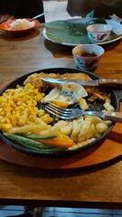 chicken steak with vegetables in hot plate