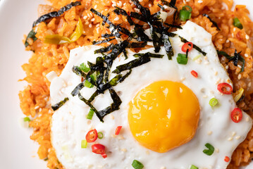 Kimchi fried rice with fried egg, pork, sesame seed, chili, spring onion and seaweed, Korean food, Close up, Top view