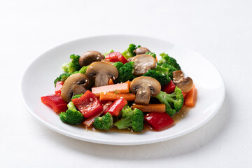Stir fried vegetables, champignon mushroom, broccoli, bell pepper and carrot with soy sauce, Asian vegetarian food, Healthy eating