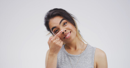 Touch nose, silly and portrait of woman in studio with funny face for emoji, comedy and humor....