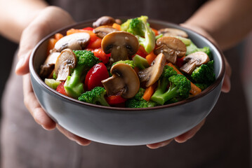 Stir fried vegetables, champignon mushroom, broccoli, bell pepper and carrot with soy sauce, Asian vegetarian food, Healthy eating
