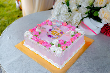 Pink wedding cake floral icing and butterfly topper design