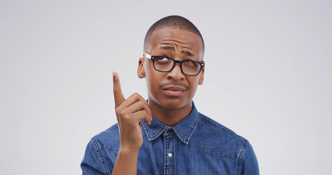 Confused, black man and thinking with solution in studio for conclusion, problem solving and aha. Space, frown and person with remember on white background with eureka moment, insight and revelation