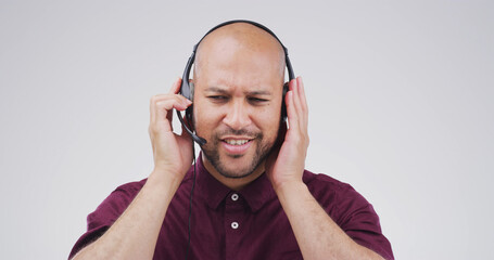 Confused, listening and call center with man in studio for FAQ hotline, customer support and debt...