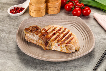 Grilled pork loin steak with bone