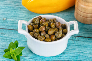 Pickled canned capers in the bowl