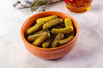 Marinated canned green cornichon cucumbers