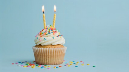 Single vanilla cupcake with white frosting and two lit birthday candles