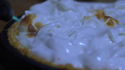 Blue flame. Lemon Pie with fluffy meringue being flamed using kitchen torch, close up - Powered by Adobe