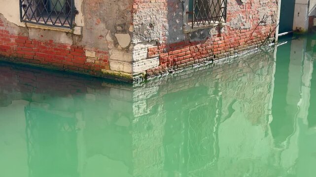 Water canal in Venice, Italy in sunny day. Slow motion 24p video recorded at 60p