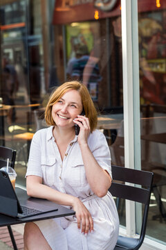 Business woman portrait outdoors talking at the phone