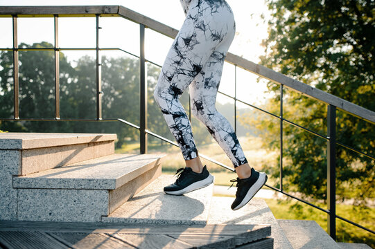 Person Running Up Stairs in Stylish Leggings