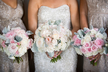 Bridal Party Holding Matching Bouquets of Soft Pink and White Ro