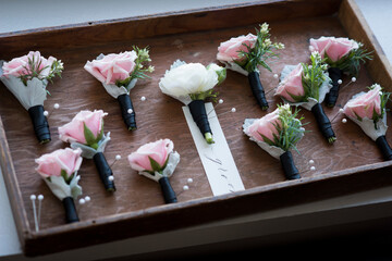Groom and Groomsmen Boutonnieres in Tray with Pink Roses