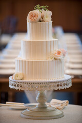Three-Tier Buttercream Wedding Cake with Soft Floral Accents