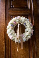 Floral Wedding Wreath with Ribbon on Wooden Door