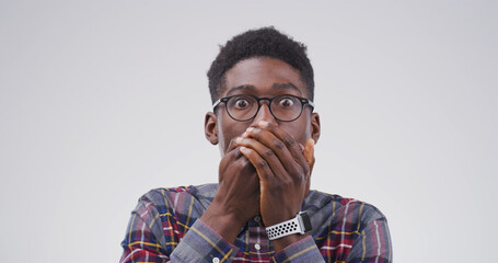 Portrait, black man and shocked expression in studio for gossip reaction, bad news and fake rumor....