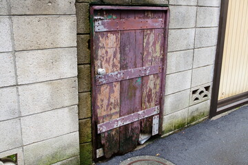 Old Wooden Backdoor and Concrete Block Wall in Downtown Tokyo, Remnant of the Showa Era