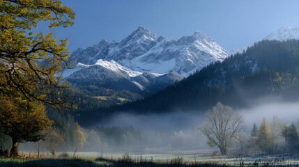 Misty Mountain Majesty: A majestic snow-capped mountain range rises majestically above a valley shrouded in mist, with autumnal trees framing the scene.
