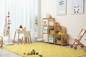 Stylish playroom with toys and furniture. Interior design