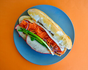 A Vietnamese style roll with salad on a plate. 